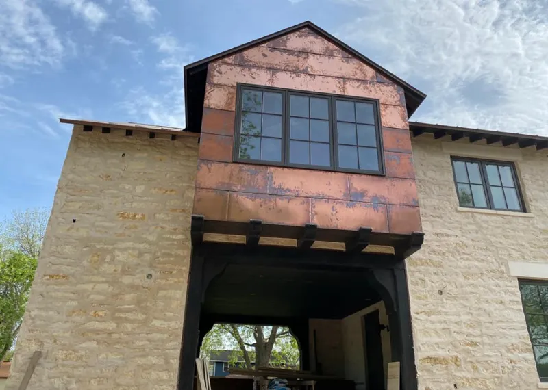 Copper metal panel facade on a stone building for Skylight Installation in Travilah